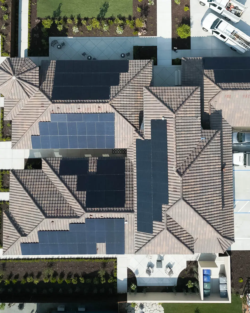 A view of a roof with many solar panels on it.